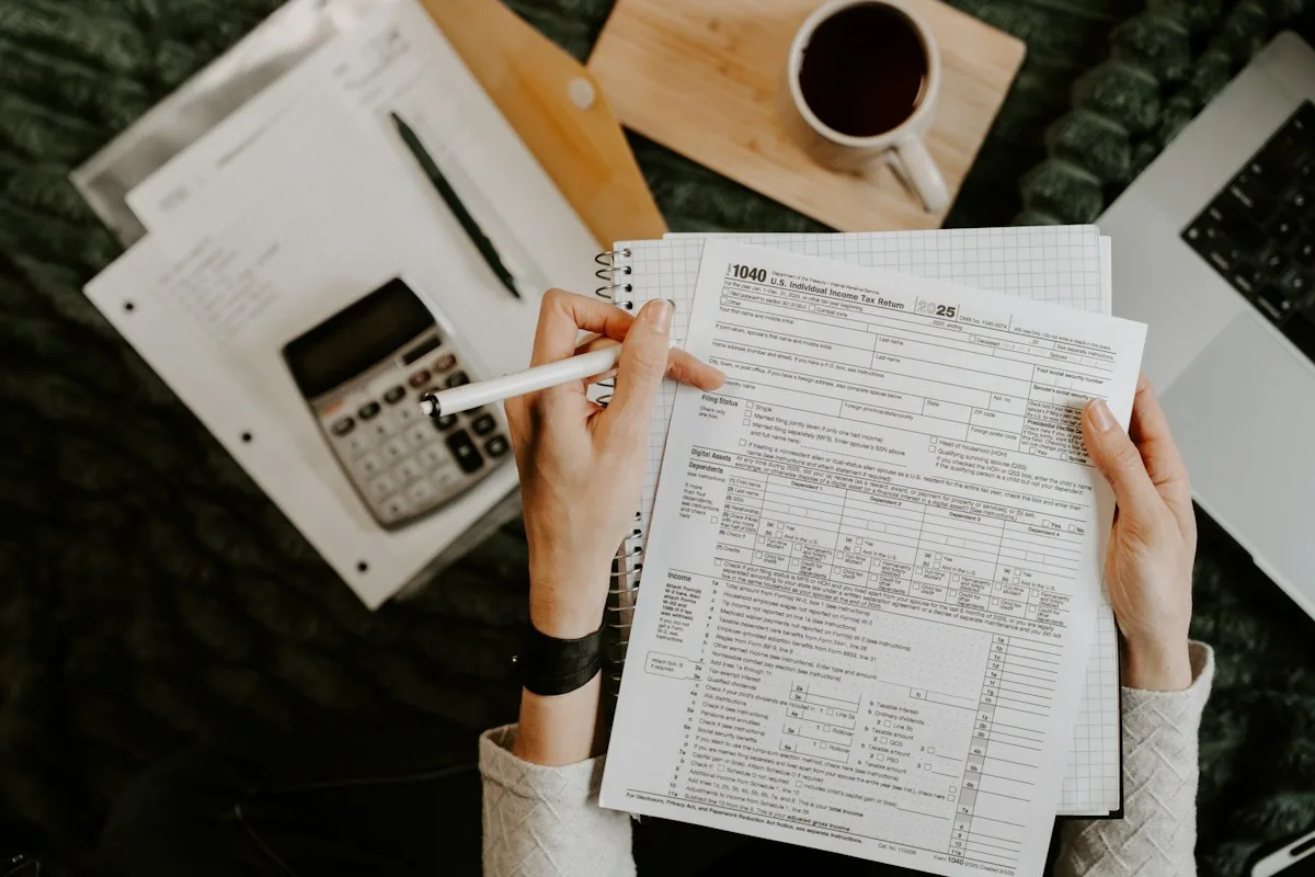 Person reviewing documents with a calculator to prepare a compliance audit