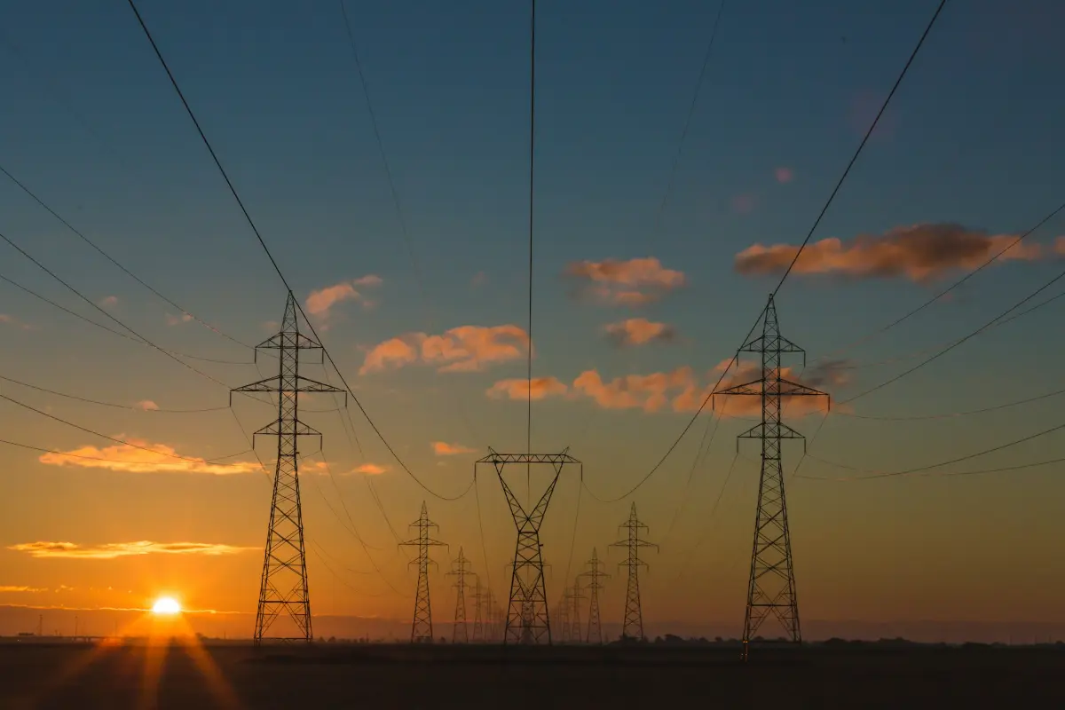 Torres de alta tensión al atardecer, infraestructura de energía sujeta a la NIS2
